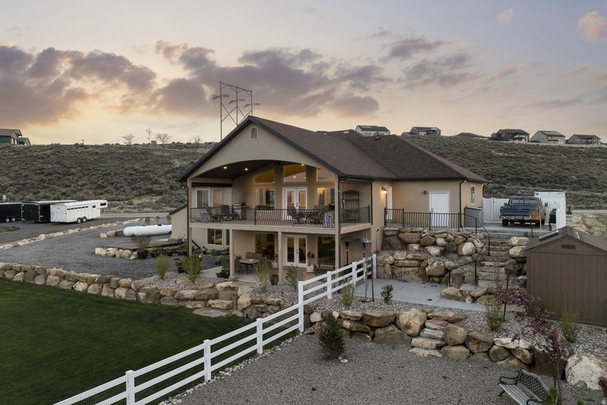 WOW. That says it all! 2.71 acres of stepped but flat horse property, custom home, AND views that will NEVER be blocked. Once-in-a-lifetime Utah property. 2 water shares with updated well, & 2 very large propane tanks on the property. Add solar and you're off grid ! Brand new basement kitchen. This has just about everything. Emergency generator, walk in mother-in-law apt., large capacity safe, huge under garage storage, horse fencing and loafing shed arriving end of April just to get started. Water and 100 AMP power to lower property for shop or barn.  $100k in landscaping in the last 2 years. You really need to see this awesome property!