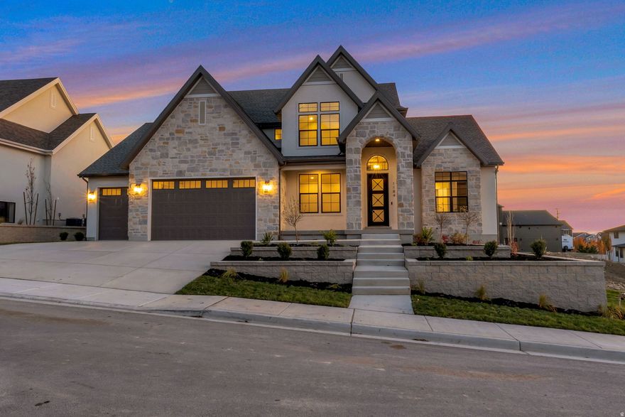 LOT#118 in Symphony Homes' Blossom Hill community. This 'Accord XL' plan is a thoughtfully designed two-story home that blends luxury and comfort with a striking two-story entry, a grand family room with soaring ceilings, custom beams, and a beautiful fireplace. Rich millwork adds warmth throughout. The kitchen features ZLINE appliances, a spacious butler's pantry, and upscale finishes. The main-floor primary suite offers a massive walk-in closet with a custom Closet Butler system. A built-in mudroom with lockers adds everyday convenience. All upstairs bedrooms have a walk-in closet. 3rd stall of garage is 40' deep with a taller door. Enjoy a covered patio and fully landscaped yard, plus a finished basement with a home gym, wet bar, cold storage, 9' foundation walls, and generous storage throughout. Style, function, and space come together in this exceptional home. Gorgeous views from the east bench! Price includes full landscaping which is expected to be completed by late October.