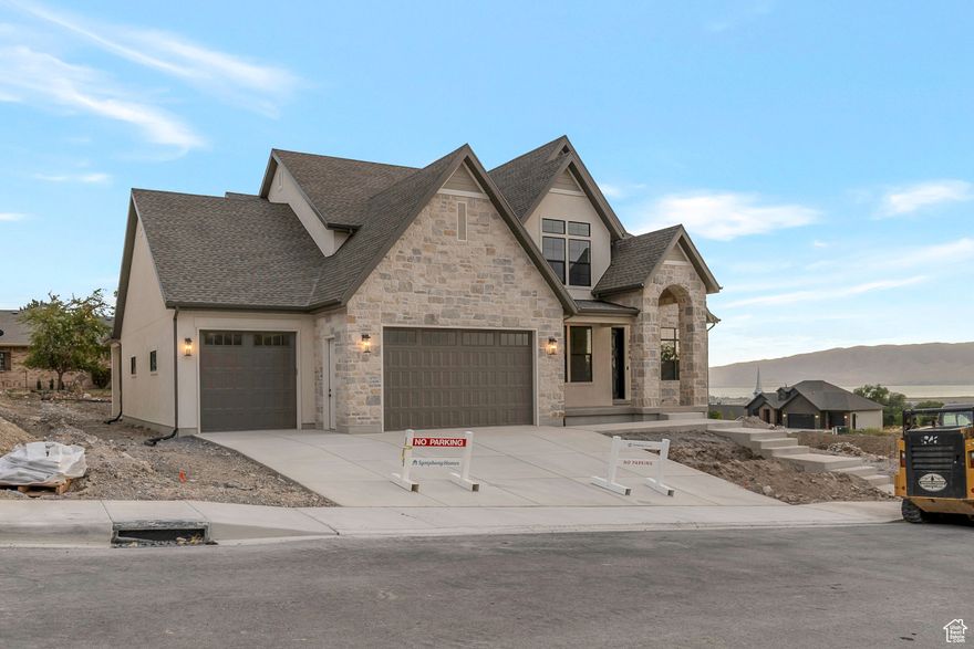LOT#118 in Symphony Homes' Blossom Hill community. This 'Accord XL' plan is a thoughtfully designed two-story home that blends luxury and comfort with a striking two-story entry, a grand family room with soaring ceilings, custom beams, and a beautiful fireplace. Rich millwork adds warmth throughout. The kitchen features ZLINE appliances, a spacious butler's pantry, and upscale finishes. The main-floor primary suite offers a massive walk-in closet with a custom Closet Butler system. A built-in mudroom with lockers adds everyday convenience. All upstairs bedrooms have a walk-in closet. 3rd stall of garage is 40' deep with a taller door. Enjoy a covered patio and fully landscaped yard, plus a finished basement with a home gym, wet bar, cold storage, 9' foundation walls, and generous storage throughout. Style, function, and space come together in this exceptional home. Gorgeous views from the east bench! Price includes full landscaping which is expected to be completed by late October.