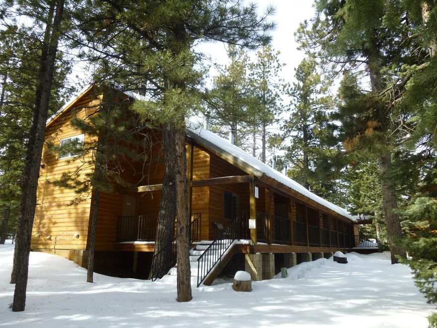 Exciting Rental Income opportunity in the beauty and cool temps of Cedar Mountain.  Ten furnished and recently updated AirBnB/Vrbo log cabin themed rental units with great potential on yearly maintained road. Two buildings are motel style, exterior walkway and connected. Units have bluetooth coded room access.  6 units are 1 bdrm loft units with a small fully functional kitchen and bathroom. 7th unit has a full kitchen, bathroom and three bedroom spaces and the 8th unit has two bedrooms, a small kitchen and a bathroom. 3rd Building houses 2 rentals, a game room space and utility space currently configured as storage and laundry. Best use for this property is multiple ST rentals, with room to do recreational equipment rentals on the side. Duck Creek visitation numbers rise every year.  First 2 buildings together are 3420 sf, 3rd bldg is 6,480 sf and has (1) 1560 sf 4BR/3BA apt, (2) 1650 sf 4BD/2BA apt, (3) 600 sf game room and (4) over 2500 sf of utility space, currently configured as storage and laundry, w/ garage door and man door access. The game room space could be a rental space or a snack bar. The many potential uses for the utility area give this property a lot of options. The 4/2 apt was managers quarters, with some staff housing upstairs.  Well situated in the national park cradle of the Grand Canyon, Zion National Park, Bryce Canyon National Park, Arches National Park, Canyonlands National Park and Capitol Reef National Park; and for area growth. This is a an AirBnB, VRBO goldmine. Seller has adjacent properties as well. Call Agent for information and showing details.