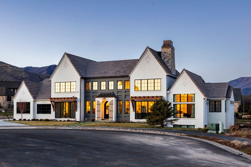 Welcome to Midway's English Manor, a home that brings the soul of the English countryside to the mountains of Utah. Reimagined with a modern, elevated aesthetic, this property blends old-world character with thoughtful, contemporary design. Every detail makes an impression: arched passageways, rich stonework, bespoke millwork, and curated textures that give the home depth, warmth, and authenticity.Seven bedrooms each feature their own distinct interior design direction, creating private retreats that feel intentional and beautifully styled. The floor plan is as functional as it is graceful, with soaring ceilings, generous living spaces, and craftsmanship that anchors the home in a sense of quiet luxury. Tucked in a peaceful cul-de-sac within Cascades at Soldier Hollow, a neighborhood that offers charm and community without losing the sweeping rural landscapes that make Midway so unique, the home is also a short drive to Deer Valley East and world-class skiing. English Manor elegance meets refined, modern living. This is a rare opportunity to own one of Midway's most distinctive and beautifully crafted homes.