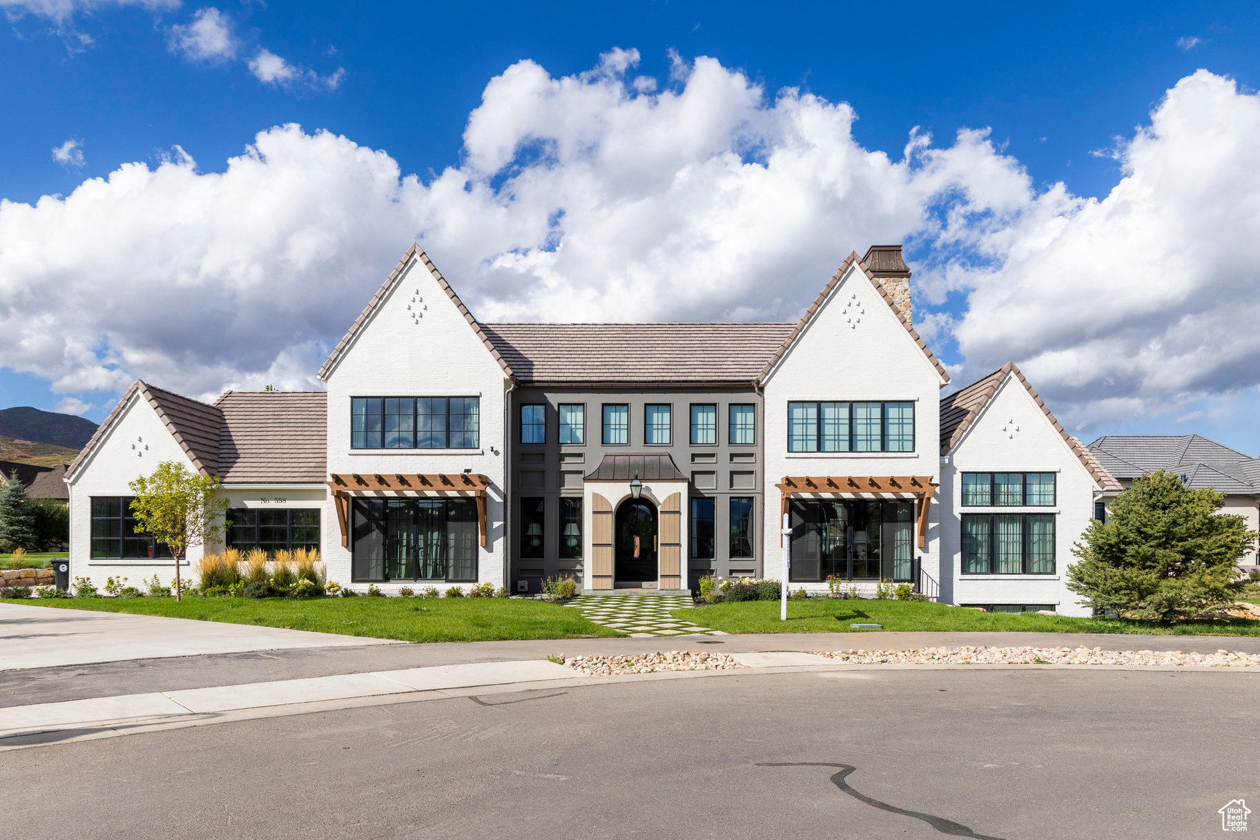 Welcome to Midway's English Manor, an inspired blend of heritage and modern sophistication. This exceptional home nods to the charm of the English countryside while embracing today's refined aesthetic. The attention to detail, from the arched doorways to the rich stonework, every corner has been thoughtfully curated. Unique architectural elements and timeless materials redefine luxury with a distinct sense of place. Inside, soaring ceilings, intricate custom millwork, and a well-proportioned layout cater to both beauty and function. Each of the seven bedrooms is its own distinct interior design style, balancing class, comfort and style. Tucked in a quiet cul-de-sac of Cascades at Soldier Hollow, the home offers easy access to all that Midway has to offer. This rare gem is a statement of timeless elegance where English manor charm meets contemporary luxury.