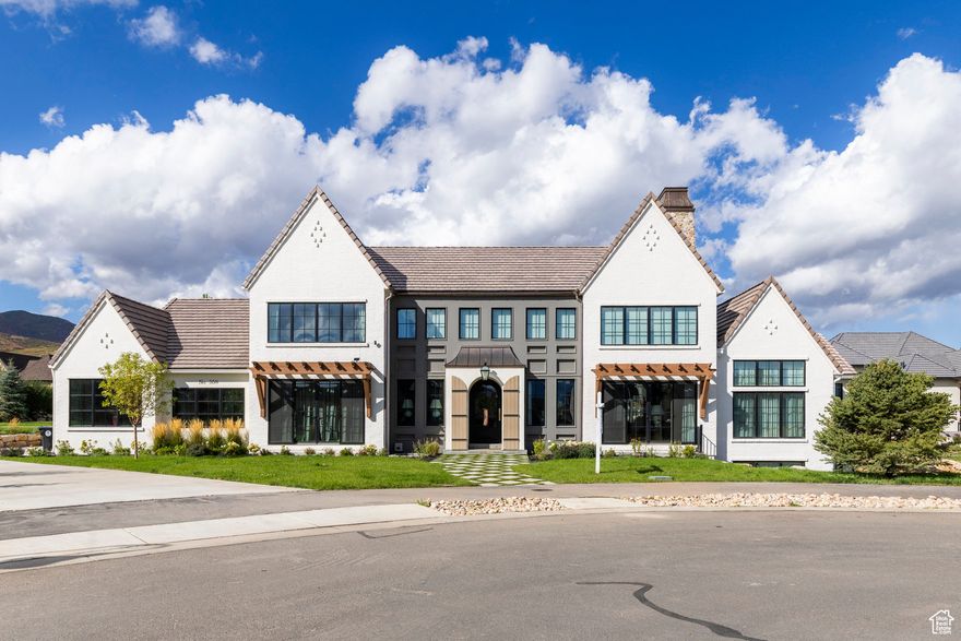Welcome to Midway's English Manor, an inspired blend of heritage and modern sophistication. This exceptional home nods to the charm of the English countryside while embracing today's refined aesthetic. The attention to detail, from the arched doorways to the rich stonework, every corner has been thoughtfully curated. Unique architectural elements and timeless materials redefine luxury with a distinct sense of place. Inside, soaring ceilings, intricate custom millwork, and a well-proportioned layout cater to both beauty and function.  Each of the seven bedrooms is its own distinct interior design style, balancing class, comfort and style. Tucked in a quiet cul-de-sac of Cascades at Soldier Hollow, the home offers easy access to all that Midway has to offer. This rare gem is a statement of timeless elegance where English manor charm meets contemporary luxury.
