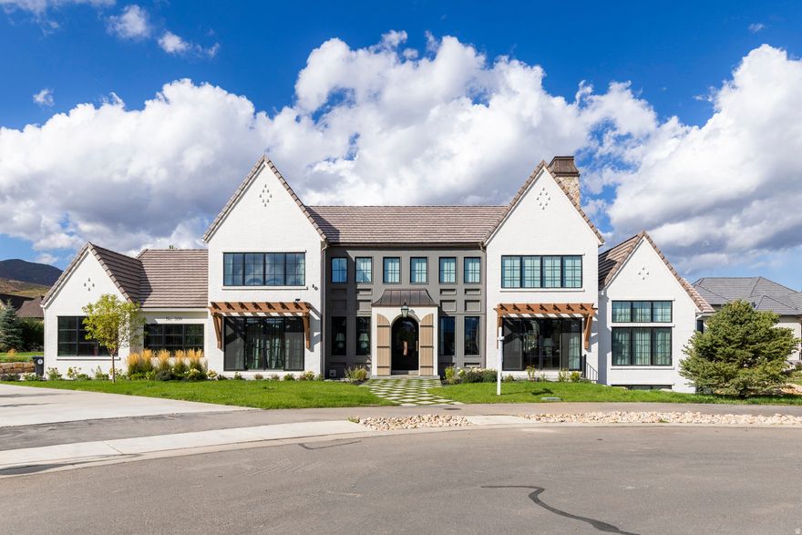 Welcome to Midway's English Manor, a home that brings the soul of the English countryside to the mountains of Utah. Reimagined with a modern, elevated aesthetic, this property blends old-world character with thoughtful, contemporary design. Every detail makes an impression: arched passageways, rich stonework, bespoke millwork, and curated textures that give the home depth, warmth, and authenticity.Seven bedrooms each feature their own distinct interior design direction, creating private retreats that feel intentional and beautifully styled. The floor plan is as functional as it is graceful, with soaring ceilings, generous living spaces, and craftsmanship that anchors the home in a sense of quiet luxury. Tucked in a peaceful cul-de-sac within Cascades at Soldier Hollow, a neighborhood that offers charm and community without losing the sweeping rural landscapes that make Midway so unique, the home is also a short drive to Deer Valley East and world-class skiing. English Manor elegance meets refined, modern living. This is a rare opportunity to own one of Midway's most distinctive and beautifully crafted homes.