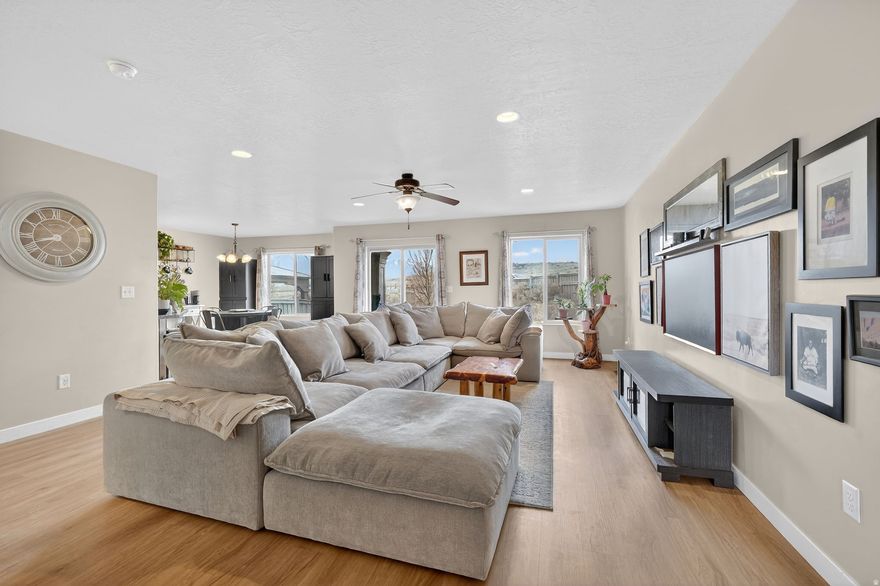Would you like the space of a Ranches-style single-family home on a townhome budget? Welcome to Mt. Airey Village, where you'll find some of the largest townhomes on the market. This home is the best price per square foot in the area and comes with so many amazing features. With all appliances included, this is a deal that can't be missed. This home is located just minutes from the region's newest Walmart, nearby Costco, and a variety of dining options. Ideally situated on the border of Eagle Mountain and Saratoga Springs, this location also offers an efficient commute to surrounding areas. The home features four spacious bedrooms on the second floor, along with a second-story, east-facing walk-out balcony perfect for enjoying morning sun. The main-floor great room provides an open and inviting space for gathering and everyday living. Downstairs, you'll find a fully finished basement suite that adds incredible flexibility. It includes a bedroom with a walk-in closet, a spacious family room, kitchenette, and bathroom featuring a gorgeous tiled shower making it the ideal space for a growing family, guests, or multigenerational living. The home features newly installed LVP Flooring, a 60 gallon water heater installed in 2024, and a 240v plug in the garage that is level 2 EV Charging ready.