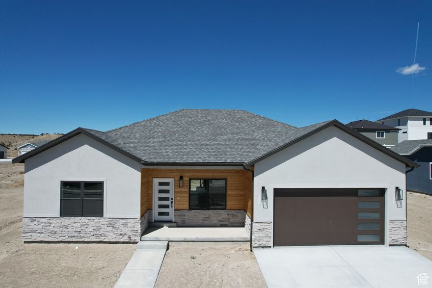 Introducing a modern style new construction home featuring Three bedrooms and two bathrooms, designed with a contemporary aesthetic and dark accent complemented by brushed nickel fixtures. This home boasts a spacious basement and a two-car garage, providing ample storage and parking space. Both bathrooms are equipped with double sinks, enhancing convenience and luxury for residents. The kitchen is a chef's dream, fitted with all-new G.E. stainless steel appliances, Corian countertops, and a farm-style kitchen sink. It also includes a pantry, closet organizers, and a special kitchen wastebasket cabinet for added functionality. The master bedroom and dining room both offer access to a charming back patio, perfect for outdoor relaxation. Additionally, all plans are plumbed for a water softener, and the garage is equipped with electric outlets suitable for electric vehicle charging. This home combines modern design, convenience, and eco-friendly features, making it an ideal choice for contemporary living.