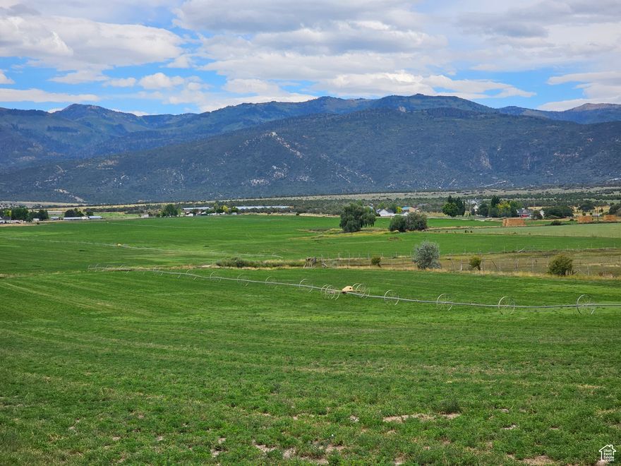 170 acres of spectacular land just outside the historic community of Spring City. There are two separate ponds feed by a spring nestled among large cottonwoods. The beauty and tranquility of this property is special! This land is in the 5 acre minimum ag zone with a portion in the RA-2 zone which allows one lot per acre.  Power lines are located along the graveled county road on the south side. This property has some excellent upside development potential. It would also make a great place for a large estate home and some livestock. The irrigation is pressurized and covers most of the acreage. Crops include alfalfa and small grains for rotation crops. Typical yield is 4.5 to 5 tons per acre. Coordinates are 39.49738, -111.4738. Elevation is 5,957 ft. Buyer to verify all information.