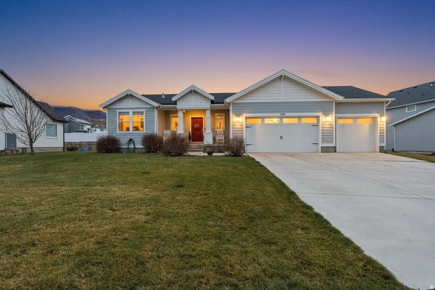 Welcome home to this stunning 2018 Red Barn rambler, one of the largest and most upgraded floorplans in the entire community. Thoughtfully designed with space, style, and comfort in mind, this home offers the rare combination of modern finishes and a wide-open, functional layout that today's buyers crave. The Grand Kitchen is truly the heart of the home, featuring an oversized island, extra cabinet storage, and expansive counter space, perfect for entertaining, meal prep, and gathering with family and friends. The open-concept design flows beautifully into the living and dining areas, creating a bright and welcoming atmosphere. The Grand Master Suite is your private retreat, complete with a spa-style master bathroom that includes upgraded space and storage, giving you the luxury feel of a custom home. Downstairs, you'll find 9-foot ceilings in both the basement and main level, making the entire home feel open, tall, and airy, ideal for future finishing, a home theater, gym, or additional bedrooms. A rare 3-car garage provides plenty of room for vehicles, toys, storage, or a workshop, while the home's newer construction means modern systems, energy efficiency, and peace of mind. Located in beautiful Santaquin, this home sits in a growing, highly desirable area with stunning mountain views, quick freeway access, and a quiet neighborhood feel, perfect for those who want space without sacrificing convenience. This is a big, beautiful rambler with all the right upgrades,homes like this don't come around often.