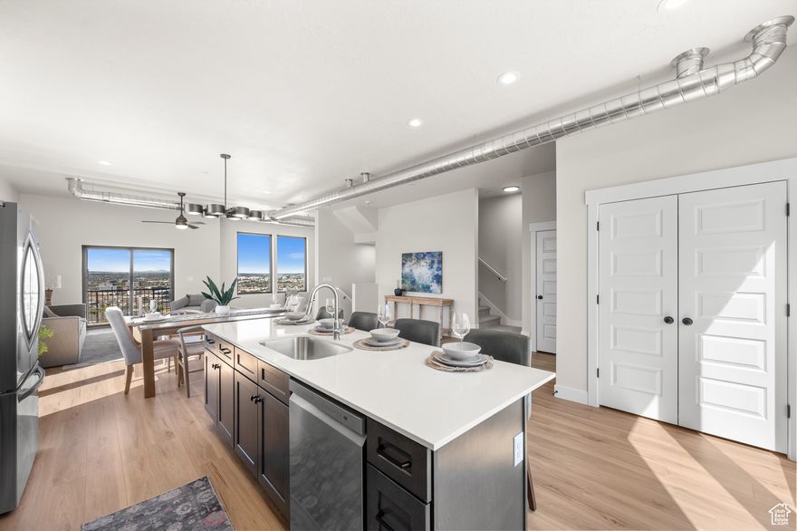 Welcome to the pinnacle of townhouse living in the Salt Lake Valley! This exceptional 4-bedroom, 3.5-bath row end unit sits at the highest elevation in the development, offering unmatched privacy, natural light, and stunning panoramic views. Boasting premium upgrades throughout, including top-of-the-line Anderson 100 Series fiberglass windows and a state-of-the-art instantaneous water heater, this home combines energy efficiency with lasting comfort.  Inside, you'll find spacious living areas designed for modern living and entertaining, flooded with natural light that enhances the open floor plan. The kitchen is a chef's dream, seamlessly connecting to the living and dining spaces, making gatherings effortless. The generous 2-car garage and expansive 4-car driveway provide plenty of parking for family and guests.  Upstairs, retreat to the spacious primary suite featuring a luxurious bathroom and ample closet space, alongside three additional well-appointed bedrooms and baths. Whether you're relaxing indoors or enjoying the fresh mountain air and valley views from your private outdoor spaces, this home truly captures the best of both comfort and lifestyle.  Conveniently located just minutes from outdoor recreation, shopping, dining, and major freeways, this standout unit offers an unparalleled blend of tranquility, luxury, and accessibility. Don't miss your chance to own one of the finest homes in the area!  3D Walkthrough: https://my.matterport.com/show/?m=UUnNakFaSwF