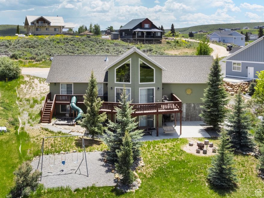 PRICE REDUCTION on this Stunning 6-bedroom, 3-bathroom home offering 3,640 square feet. Situated adjacent to Sweetwater Golf Course with breathtaking views of Bear Lake and the surrounding mountain ranges. This turnkey property comes fully furnished and is currently set up to sleep 31 guests, making it an ideal investment for short-term rentals or a spacious private retreat. Inside, guests will love the shuffleboard, hockey table, foosball, and skeeball, providing endless indoor entertainment. Designed for both comfort and entertainment, the home features expansive windows and sliding glass doors that showcase the stunning scenery while filling the interior with natural light. Outside, the property offers a firepit and playground. With its prime golf course location, modern amenities, and ready-to-rent setup, this home is a rare opportunity to own a highly desirable Bear Lake retreat. Whether you're looking for a personal getaway or an income-generating property, this home delivers the ultimate in comfort, recreation, and scenic beauty. Buyer to verify Square Footage; Numbers provided by the Seller.