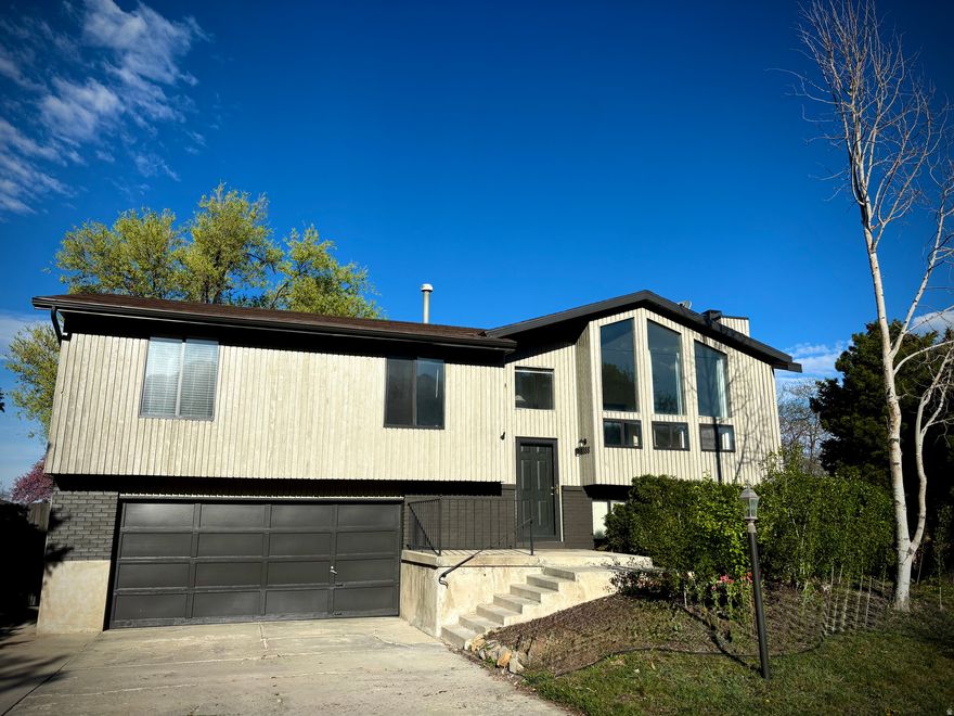 Welcome to this beautiful home in the desirable Willow Creek area of east Sandy. Nestled on a quiet street away from busy roads, this property offers privacy with stunning mountain views. Recent upgrades include new premium exterior paint (including deck refinishing), new flooring in kitchen/dining area and entryway; newer roof, HVAC system and water heater, stainless steel appliances, quartz counters and carpet.  Spacious layout boasting 4 bedrooms, 2 bathrooms, cathedral ceilings, and abundant natural light. Downstairs suite includes walk-in closet, jetted tub, and private sitting area. Large, fully fenced backyard perfect for gatherings, pets, or play and oversized 2-car garage plus RV parking. This home combines comfort, functionality, and location - just minutes from recreation, including four world class ski resorts, shopping, and the country club. A rare find in a sought-after neighborhood!