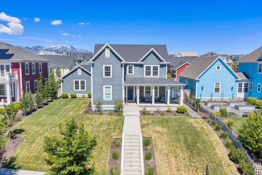 Welcome to this immaculate Daybreak home, ideally located just a few blocks from Oquirrh Lake with stunning Wasatch Mountain views and easy access to trails and outdoor recreation. Thoughtfully designed with exceptional indoor and outdoor living spaces, this home offers both luxury and comfort in one of Daybreak's most desirable locations.  The inviting wraparound covered porch is the perfect place to enjoy both sunrises and sunsets, while the beautifully landscaped backyard is designed for entertaining with a covered pergola, chef-style grill station, dry bar seating, stone gas firepit, and generous lawn space.  Inside, soaring ceilings, oversized windows, and abundant natural light create a bright and airy atmosphere throughout. The living room features a cozy fireplace and access to the wraparound porch for seamless indoor-outdoor living.  The chef's kitchen showcases a custom backsplash, gorgeous granite countertops, pendant lighting, ample cabinetry, a spacious pantry, and generous island seating.  The bright primary suite offers a relaxing retreat with TWO spacious walk-in closets featuring built-in shelving and hanging storage. The ensuite bathroom includes dual granite vanities, a soaking tub, and a euro shower.  Additional highlights include a spacious home office, mudroom-style garage entry, and a fully finished basement with a private entrance and impressive wet bar kitchenette complete with beverage fridges.  A Control4 system turns this home into a true smart home, allowing you to control lighting, climate, security, and entertainment from one simple interface. Speakers throughout the home, including the garage, back patio, and front porch, create a seamless audio experience while adding convenience, security, and a luxury "push-button" lifestyle.  This beautifully maintained home combines thoughtful design, incredible entertaining spaces, and the unmatched Daybreak lifestyle. Schedule a showing and tour this unparalleled Daybreak gem today!