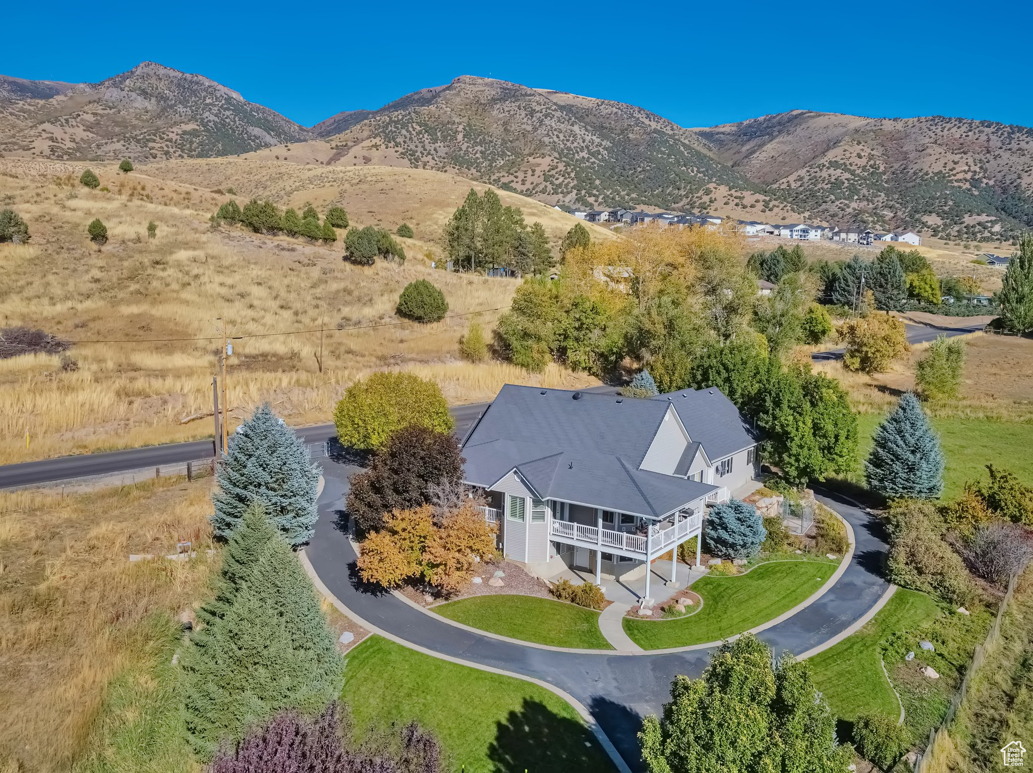 Set in quiet, picturesque Morgan Valley. This sprawling property offers room to grow, privacy, and views like crazy! Just an hour from Salt Lake. Surrounded by farmland with its own private well, backup generator, and huge oversized heated 3 car garage. Income producing basement, if you are interested, with separate entrance, kitchen, laundry, and 2 bedrooms. Custom finishes throughout. Count the deer in the field as you enjoy the view from the kitchen, dining and office. Separate tub and shower in master bedroom. Wraparound trex deck with vinyl railings. Security gate and dog run both stay to round out such a complete property. Call today for a visit!