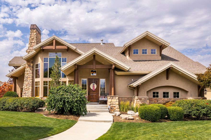 Welcome to this elegant home nestled in the heart of Draper. Ideally located between Salt Lake City and Utah Valley, this prime location offers quick access to freeways, world-class skiing, scenic mountain biking trails, and top-rated schools. From the moment you step inside, you'll be captivated by the stunning grand staircase - a true architectural showpiece that sets the tone for the entire home. The main level boasts soaring vaulted ceilings, a dramatic two-story fireplace, and a spacious office with a private entrance, perfect for remote work or client meetings. Natural light pours through expansive windows, creating a bright and welcoming atmosphere throughout. The gourmet kitchen features a gas range, double stainless steel ovens, and a large walk-in pantry. The fully finished basement offers additional living space complete with a kitchenette. Step outside into your private backyard oasis - beautifully landscaped and thoughtfully designed for both relaxation and recreation. Enjoy a covered patio, hot tub, tranquil water feature, fire pit, and an in-ground trampoline.