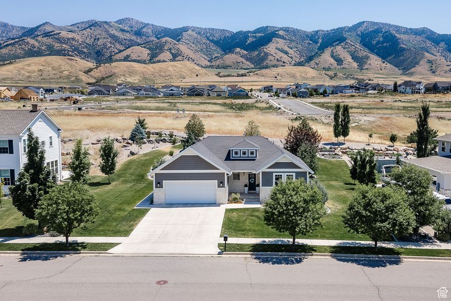 This beautifully crafted custom home nestled on Hyde Park's east bench, offering panoramic views and spacious, upgraded living is for lease or for sale. Custom kitchen featuring a large island, white cabinetry, granite countertops, and plenty of space for a full-size dining table. The open-concept living room a includes a modern electric fireplace and is filled with natural light . Durable and stylish LVP flooring throughout the home. 4 generously sized bedrooms, 4 full bathrooms, and 2 large living areas. Step outside to your private, covered east-facing patio-ideal for evening BBQs, complete with a gas line hookup for grilling. Located in a quiet neighborhood near the mountains