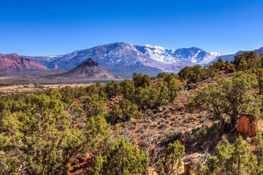 ELEVATED VIEWS & SCULPTED LANDSCAPE  Perched high above the legendary landscape of Castle Valley, this 6.57-acre estate offers a rare vantage point with direct, unobstructed views of Castleton Tower and the La Sal Mountains. This isn't just a parcel of land; it is a front porch seat to the crimson sunrises and starlight nights that define the Moab region. Surrounded by natural boulders and desert evergreens, simply connect to Starlink and you have the ultimate off-grid "work & play" desert escape.  READY TO BUILD - A storage studio that is connected to a septic system is already in place. The property features a professionally graded, S-shaped driveway, creating a natural scenic access point and multiple pads for parking or trailer while planning your permanent retreat. The sale includes 0.45 acre-feet of domestic water rights from a natural spring. For the right offer, the seller is willing to include a 1992 Sun Lite Discover trailer and a rugged 2002 Jeep Wrangler to enjoy your new domain from day one.  THE PINNACLE OF PRIVACY AND VIEWS - Situated strategically above the valley floor and the last lot on the street, you have the space to create a legacy desert home with privacy. An integrated outdoor platform and storage studio is already in place, offering the perfect footprint for a yoga deck, telescope station, or a basecamp for sleeping under the stars.  PRIME LOCATION AND OUTDOOR ACTIVITIES AT YOUR DOORSTEP! You are minutes from the Colorado River, the Porcupine Rim for mountain biking, and the La Sal Mountains for world-class recreational activities.  Secure your piece of the Utah desert today, where the only thing more vast than the landscape is the potential for your future legacy home.