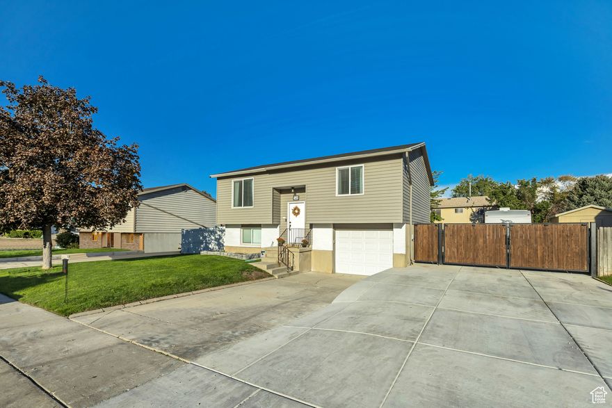 Welcome to this beautifully maintained 3-bedroom, 2-bathroom home offering 1,692 sq. ft. of living space. Conveniently located near Bangerter Highway and I-215, you'll enjoy quick access to shopping, dining, and everyday conveniences.  Step inside to a bright, functional layout designed for comfort and ease. The exterior features a fully fenced yard, perfect for pets or outdoor gatherings. Recent upgrades include brand-new RV parking with a secure gate and a new mailbox, adding both practicality and curb appeal.  Square footage figures are provided as a courtesy estimate only and were obtained from county records.  Buyer is advised to obtain an independent measurement.