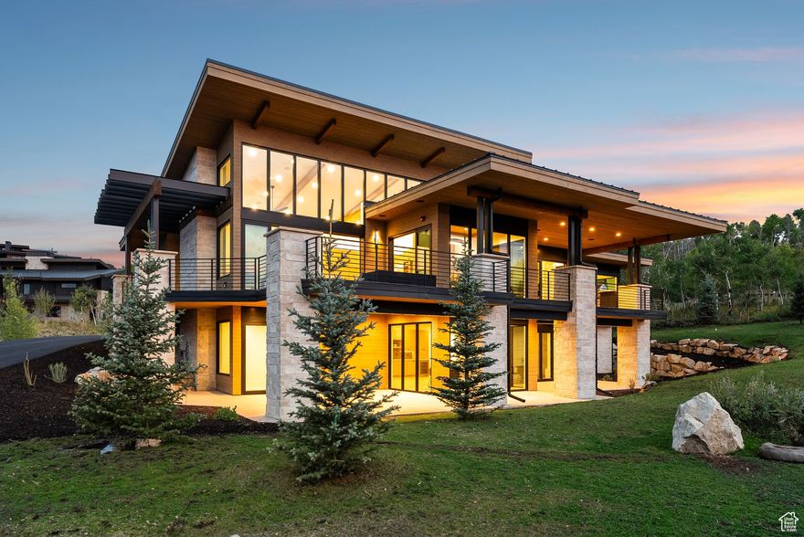 This mountain masterpiece is nestled within one of the largest natural aspen groves in Promontory, directly off the 33+ mile trail system with direct access to club amenities. Thoughtfully designed for year-round living and multi-generational lifestyles, the home offers 5 bedrooms, 7 baths, a dedicated office, gym, and media room.  Panoramic mountain views fill floor-to-ceiling windows and a dramatic five-panel soft-close multi-sliding door, complemented by a glass-wrapped dining room with additional sliders on both sides. Multiple covered patios extend the living experience outdoors with a built-in grill, cedar soffits, and a fire pit-perfect for entertaining. The chef's kitchen features Thermador appliances, a massive island, designer lighting, and a walk-in butler's pantry-ideal for living and hosting.  The main-level primary suite includes a spa-inspired bath with heated floors, expansive sliders opening to a private terrace, and a walk-in closet. The lower level offers three ensuite bedrooms, a custom ensuite bunk room, full gym, wet bar, family room, and second laundry.  Built for comfort and efficiency, the home features upgraded spray-foam insulation, enhanced sound-deadening between floors, and three HVAC zones. It's pre-wired for sound, smart home systems, security, and electric shades.  A Full (Golf) Club Membership is available, letting you skip the 130+ waitlist and enjoy one of the Mountain West's most extensive amenity packages: three private golf courses, six dining venues, 11 clubhouses, a spa and fitness center, and the only mountain Beach Club-tubing hill in winter. Private ski-in/ski-out lodges at Deer Valley and Park City Mountain provide concierge service, gear storage, shuttle access, and transport to Main Street. Additional amenities include concerts, events, kids' camp, aerial yoga, pickleball, bowling, equestrian, hiking, biking, fishing, and more-delivering an unmatched mountain club lifestyle.