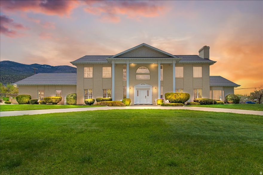 Escape the hustle and bustle of city life and discover refined country living in this beautifully crafted custom home nestled at the base of the Manti-La Sal National Forest. Located in a quiet rural town with a population of just 3,500, this property offers the peace, charm, and space that country living is all about. Situated on a full acre, the possibilities are endless with room for a swimming pool, pickleball or tennis courts, gardening, and more.Built with quality throughout, this spacious home features 5 oversized bedrooms, 3 bathrooms, formal living and dining rooms, and exceptional craftsmanship at every turn. The kitchen showcases stunning hickory cabinetry with updated hardware, while the home is enhanced by imported 100% wool carpet from England and new windows installed at a cost of $14,000. The unfinished basement offers incredible potential with plumbing already in place for an additional bathroom and kitchen, two fireplaces, three separate entrances, and ample space for a future apartment, guest quarters, or Airbnb opportunity. Additional highlights include a massive 1,140 sq ft garage, large parking area on the east side of the home, excellent insulation for energy efficiency, and most furnishings/furniture included in the sale. This is a rare opportunity to own a high-quality home with space, privacy, and endless possibilities in a breathtaking mountain setting.