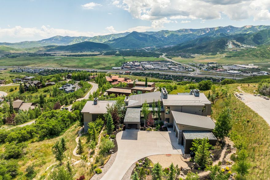 Reintroduced for the 2026 golf season at $11,400,000, this striking contemporary estate in the private, gated Glenwild community reflects the vision of architect Jeff Shindewolf (JSARC, formerly with Upwall) and the craftsmanship of esteemed builder Steve Dubell-an exceptional pairing in Park City design and construction. Positioned privately on 1.63 acres, the nearly 10,000-square-foot home is designed to take full advantage of its panoramic sightlines stretching from Olympic Park to Deer Valley. Floor-to-ceiling glass walls open to more than 3,300 square feet of outdoor living space, creating a natural flow between interior and exterior environments. This home offers six en-suite bedrooms, multiple spaces for gathering and entertaining, and a level of finish and construction quality that would be both challenging and significantly more expensive to achieve today. A standout offering in Glenwild, this property presents a rare chance to secure a long-term legacy home in one of Park City's most sought-after communities.
