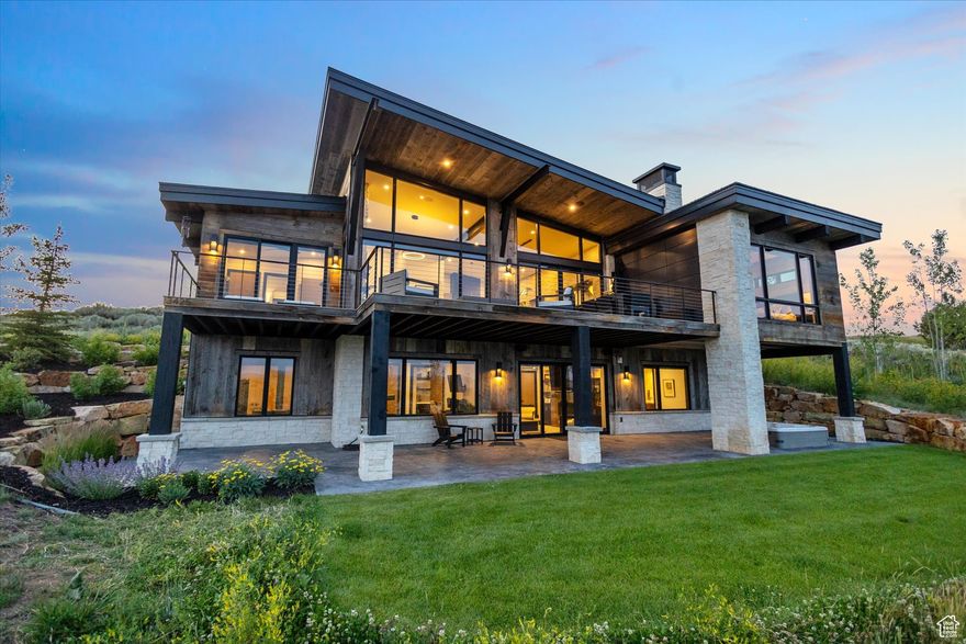 Welcome to your mountain sanctuary-an exquisitely crafted, 4.5-bath custom home in the private, gated community of Tuhaye. Set on 0.83 acres at the end of a quiet cul-de-sac, this 4,050 square foot residence blends timeless design with exceptional craftsmanship, offering sweeping southern views of the Uinta Mountains and Victory Ranch below. Designed for comfort and entertaining, the main level features a sunlit great room with floor-to-ceiling windows, wide-plank hardwood flooring, and a seamless flow between the kitchen, dining, and living spaces. A chef's dream kitchen is outfitted with Thermador appliances, including a six-burner gas stovetop with griddle and double ovens. Enjoy outdoor living and dining from the expanded south-facing deck that captures breathtaking fire-side views and year-round mountain beauty. The home offers two luxurious primary suites on the main level, with additional bedrooms and a large game room on the lower walkout level. A hidden speakeasy adds a unique and memorable touch-perfect for intimate gatherings or aprs-ski evenings. The lower patio offers more space to entertain with a hot tub and spectacular views. Austin limestone and reclaimed barn wood add warmth and texture throughout the home. Designer lighting by Hubbardton Forge and radiant-heated tile floors further elevate the space. The oversized garage includes built-in cabinetry and an epoxy finish for a clean, custom look. Full Talisker Club Membership is available, granting exclusive access to a wealth of world-class amenities: the Tuhaye clubhouse, Basecamp, Moondance, Wildstar Kids Club, spa, fitness center, pools, tennis, pickleball, mountain biking trails, and the Mark O'Meara-designed championship golf course, plus a 9 hole par three course. You'll also enjoy access to Talisker's Empire Pass amenities, including the ski-in/ski-out ski lounge at Silver Strike,stunning lodge, pool, fitness center, and brand new spa.  Talisker Club Membership available with separate purchase. Buyer to verify all info.