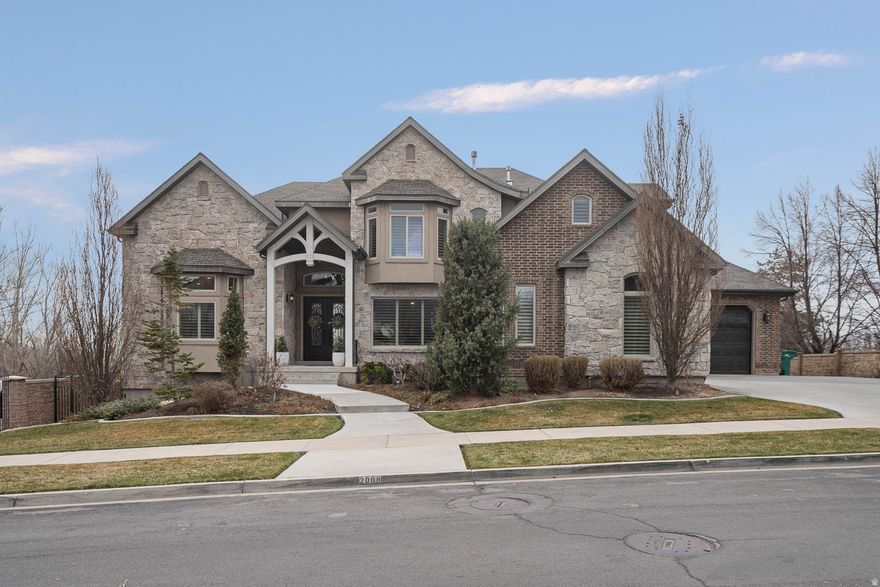 Discover refined living in this stunning luxury residence that perfectly blends elegance, comfort, and exceptional functionality. This large, beautifully maintained home showcases a gorgeous updated kitchen designed for both everyday living and entertaining, featuring high-end finishes and timeless style.  Step outside to your own private retreat where a spectacular pool and swim spa are surrounded by a meticulously manicured yard with mature landscaping, creating a serene and resort-like setting. The outdoor space offers both beauty and privacy, ideal for relaxing or hosting gatherings.  Inside, the home is immaculately cared for and reflects true pride of ownership throughout. The spacious primary suite is conveniently located on the main level, offering comfort and accessibility. A private mother-in-law suite provides excellent flexibility for guests, extended family, or multi-generational living.  Car enthusiasts and hobbyists will appreciate the expansive 4-car garage, along with the rare bonus of an excavated dance room and additional storage beneath both garage floors-offering incredible space for recreation, storage, or specialized use.  Ideally situated in a central and highly convenient location, this home offers quick access to I-15 and is just minutes from shopping, dining, and entertainment, making everyday living as effortless as it is enjoyable.  This remarkable home combines luxury, thoughtful design, and impeccable upkeep, creating a truly exceptional place to live.  Buyer to verify to Buyers satisfaction.