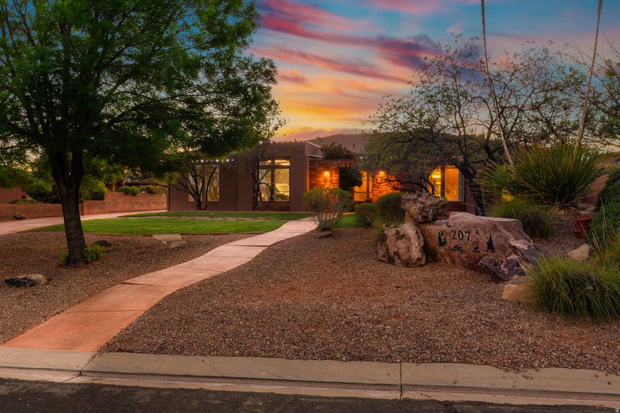 Experience the beauty of Southern Utah living in this stunning Southwest-style home, perfectly positioned to capture breathtaking red rock views. Thoughtfully designed with both comfort and entertaining in mind, this property offers a seamless blend of indoor and outdoor living. The inviting living room features a striking stone fireplace, creating a warm and welcoming focal point. A dedicated theater room provides the perfect space for movie nights and entertaining. Step outside to an exceptional outdoor setting, complete with an expansive patio and a large yard designed for both relaxation and play. The private pool, featuring a fun slide, adds a resort-style touch that's perfect for enjoying sunny desert days. The home's charming courtyard entry enhances its Southwest character, offering a peaceful and stylish introduction to the space within. With its unique architectural details, incredible views, and standout amenities, this home delivers the ultimate Southern Utah lifestyle.