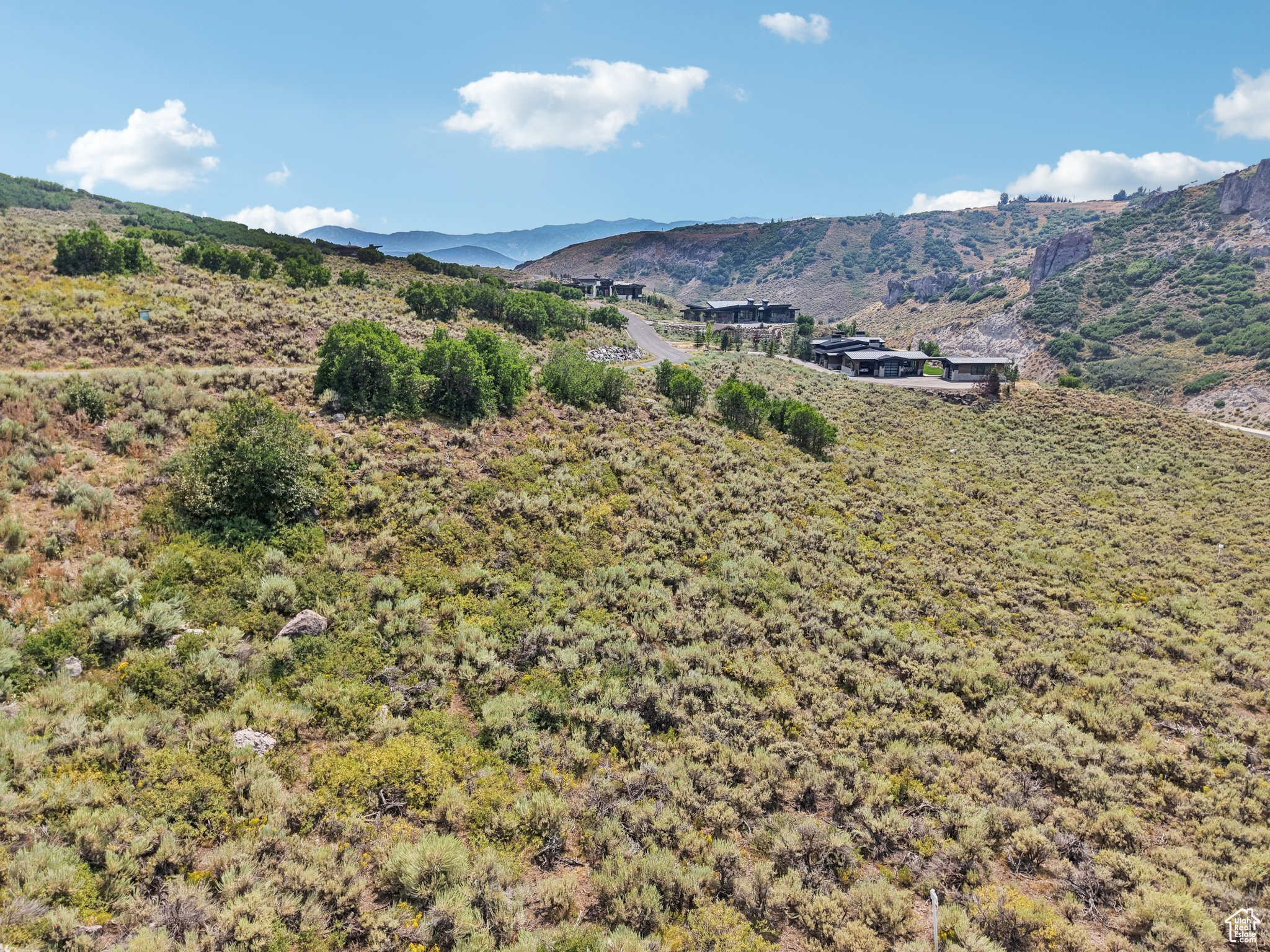Enjoy panoramic views of rugged rock cliffs in Northgate Canyon, as well as open space, mature gamble oak, and the local resort peaks. This 1.25-acre lot has a gently sloped terrain and utilities at the street- ready for you to build your dream mountain retreat in stunning natural surroundings. While additional amenities available by acquiring a Club Membership, all residents enjoy the community's extensive private trail network, scenic surroundings, and proximity to Park City's world-class skiing, dining, and entertainment. Hop on I-80 for a short drive to Salt Lake City International Airport. Whether you're seeking peace, views, or a prime location for your future home, this lot offers exceptional value and lifestyle potential!