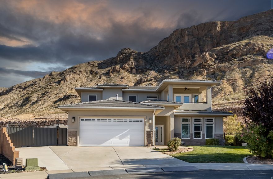 Enjoy sweeping views of Pine Valley Mountain, Yant Flat, and the red rock cliffs from this 2,622 sq ft Hurricane home with no HOA. Built in 2014 and gently lived in, it offers 10' ceilings, wood-grain tile, 2x6 construction, and full accessibility with a private elevator, widened doors, and a roll-in shower. The kitchen features a large pantry, double oven, and wine fridge. Upstairs includes a second living area, laundry, and room to add a 3rd bedroom and bath. RV parking, extra garage storage, and a backyard gazebo complete the home, along with a quiet setting near trails and outdoor recreation.