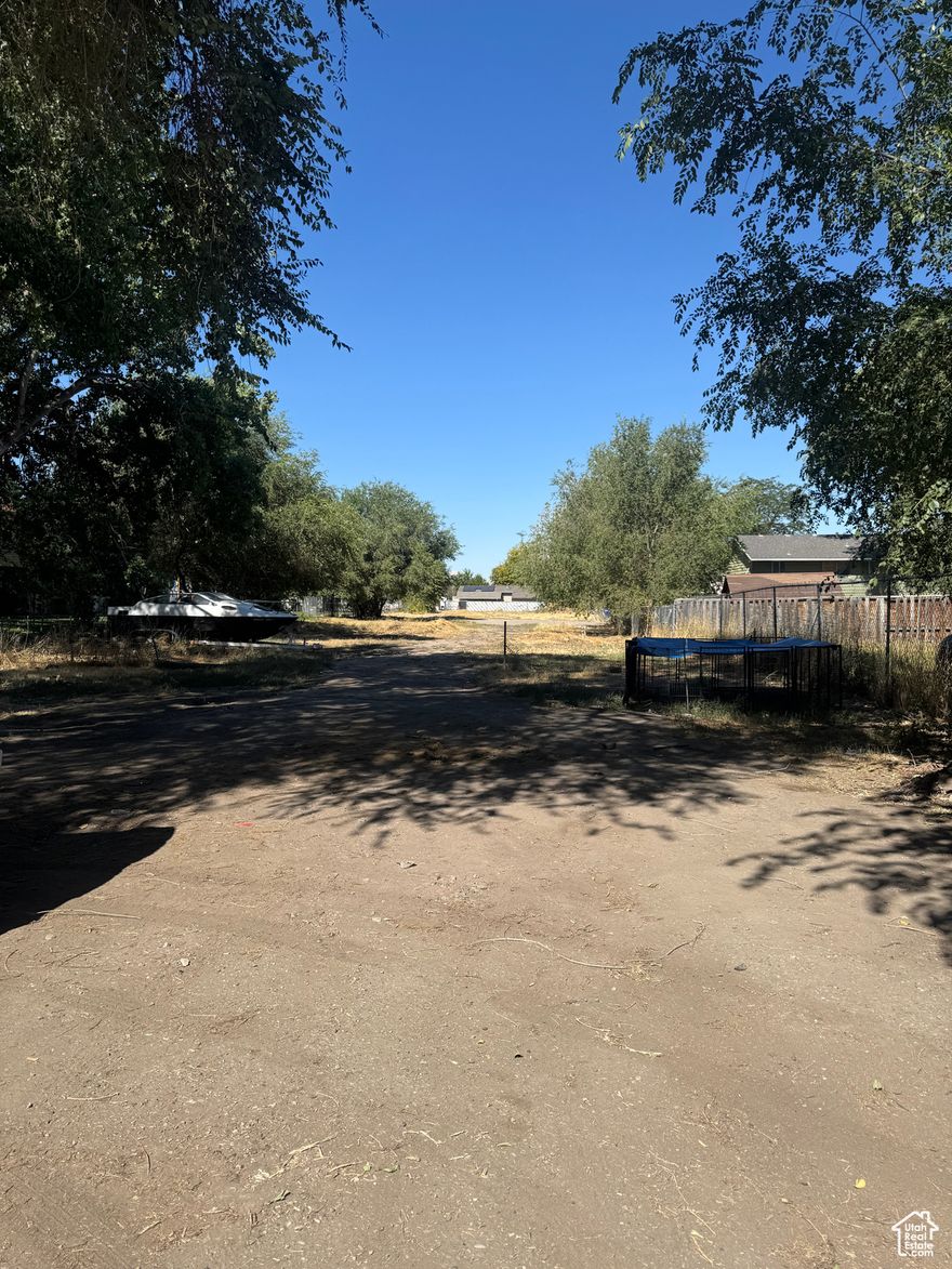 4 Great Land development opportunity.( There is an income-producing 4-plex on the property)  0.94 Acres. The value of this property is in the land for developing new homes or apartments. There are two different entryways to the property, one off of Redwood Road and the other off of Gemini Street. Great investment for Apartments or New townhomes to be built. There is a four-plex on the front of the land that brings in a monthly cash flow of around $4,000. Bring your builder, great location close to Trax. Figures are provided as a courtesy estimate only; the Buyer is advised to obtain independent measurements. DO NOT DISTURB TENANTS!! Seller is participating in a 1031; cooperation is requested.