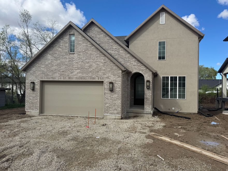 Move-in-ready mid April! This is not your typical builder spec home.  Every inch has been custom designed with a classic yet modern vintage vibe. Finishing details plus included front and back landscaping going in soon.  This lux cottage two-story features a classic brick exterior, custom bronze and glass arched front door and grand entry with wainscoting and checker pattern tile. Features a gorgeous chef's kitchen with classic maple and taupe shaker cabinets, stunning  gold hardware and lights,  and included appliance package.  9ft ceilings on the main and in the finished basement with separate entrance. Extra Large side yard works great for RV or Extra parking. All Located in the heart of Millcreek . . . an area loved by generations for being central to downtown life and the mountain adventures alike. Call for more details and to secure one of these masterpiece homes now.