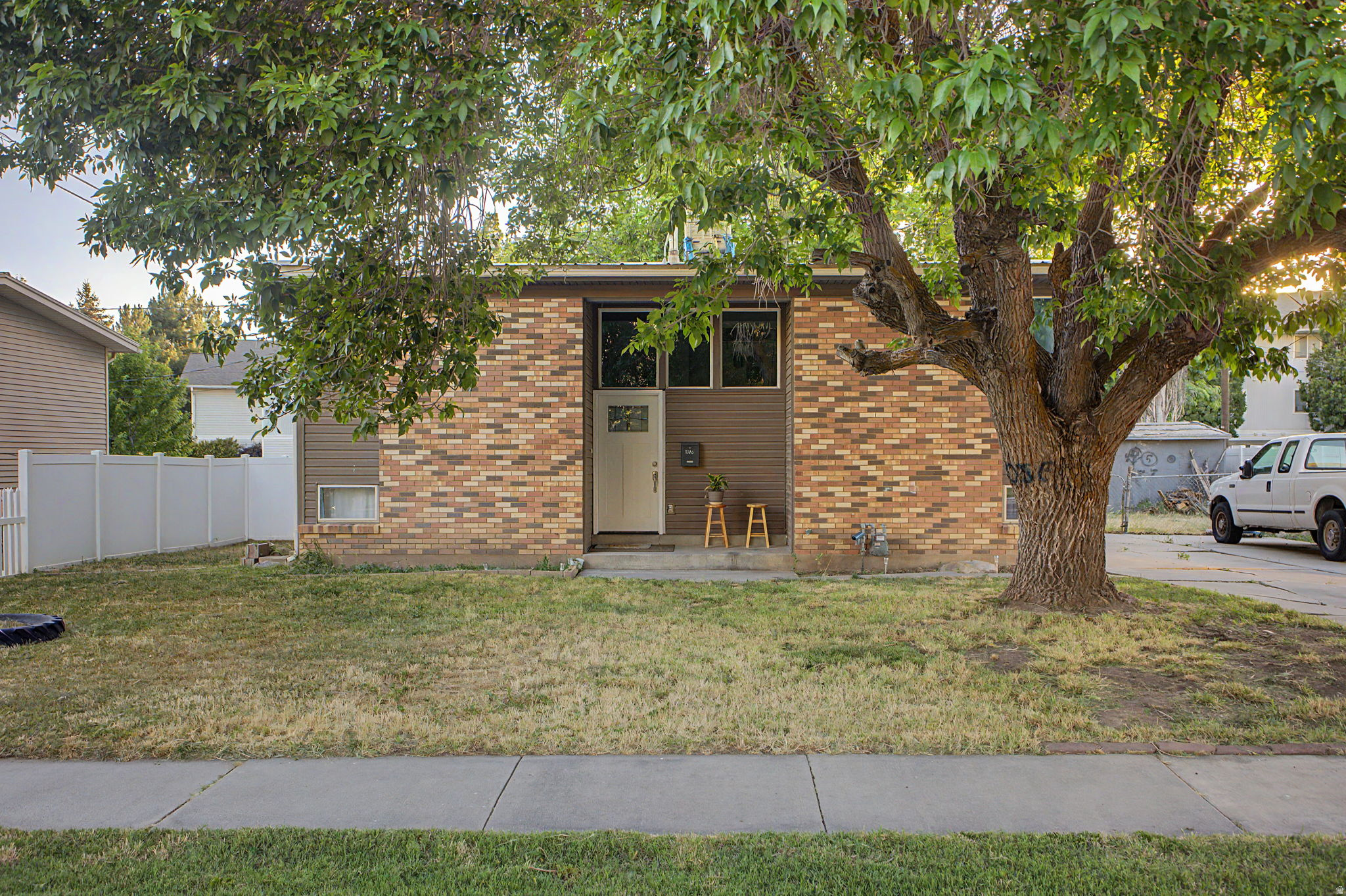 Brick and siding facade with a white front door featuring glass panels