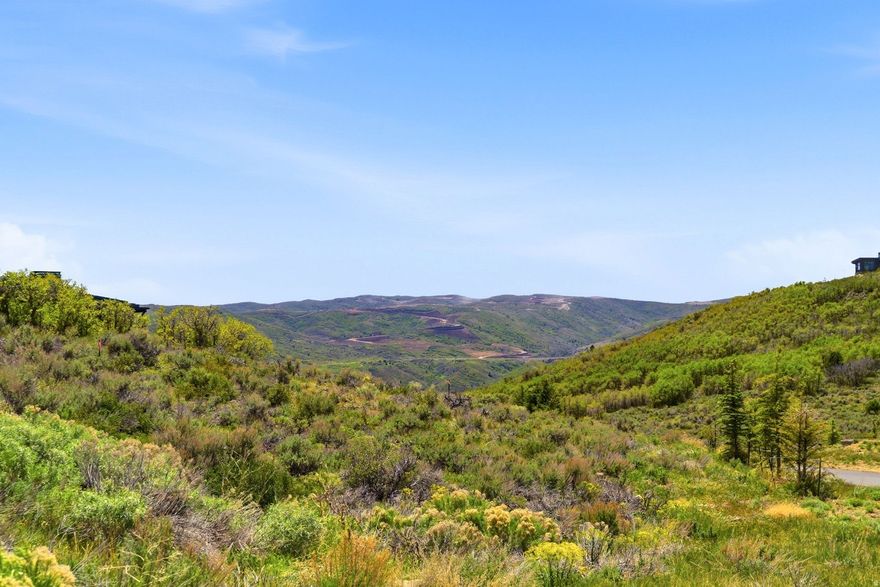 Discover this stunning south-facing homesite in Tuhaye, perfectly positioned to capture views down a serene natural draw and the breathtaking mountain landscape beyond. This exceptional downhill building site offers convenient access in and out of Tuhaye, along with close proximity to the Club's premier amenities. Enjoy a short walk to Moondance Park and the Pavilion, or head out on the Hoodoo Trail for a scenic hike down to the Jordanelle. The list price INCLUDES $200,000 for the Talisker Club Membership initiation/joining fee, offering access to an extraordinary four-club lifestyle. Talisker Club spans Tuhaye, Empire Pass, Courchevel Bistro on Main Street, and The Outpost--delivering a rare combination of mountain recreation, private golf, ski-in/ski-out access, dining, wellness, and adventure. In Tuhaye, residents enjoy the Signature Mark O'Meara championship golf course, the Village at Tuhaye Golf Clubhouse, pools, spa, fitness center, tennis courts, Moondance Park, and miles of hiking and biking trails. At Empire Pass, members enjoy access to the private Talisker Tower Clubhouse with ski-in/ski-out convenience. Courchevel Bistro offers a private members-only lounge in the heart of Old Town, while The Outpost provides a backcountry escape with a private yurt, snowmobiling, snow tubing, private dinners, hiking, and more.