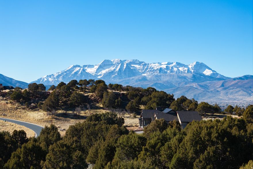 Nestled on a beautiful 0.77-acre homesite blanketed with mature juniper trees, this exceptional property offers sweeping views of the Wasatch Mountain Range and the south valley, creating a serene mountain backdrop in every season. The gently sloping lot provides an ideal setting to design a custom mountain retreat that blends seamlessly with its natural surroundings while capturing breathtaking sunrises, sunsets, and expansive alpine vistas.  Located within the prestigious Red Ledges private community, the homesite is just moments from the Red Ledges Equestrian Area, operated by KB Horses. Residents enjoy a full-service equestrian program featuring guided trail rides, private lessons, horsemanship clinics, horse leasing, and magical winter sleigh rides through Utah's stunning mountain scenery. Miles of trails weave through the community and adjoining open spaces, offering unforgettable outdoor experiences for riders of all skill levels.  Only 12 minutes from the East Village and world-class Deer Valley skiing, this location delivers the perfect balance of privacy and accessibility. Red Ledges provides convenient ski shuttle services, and ownership includes complimentary access to the exclusive Deer Crest Club, Stag Lodge, and Mariposa, elevating your mountain lifestyle with unmatched luxury, dining, and ski-in/ski-out amenities. This homesite presents a rare opportunity to build in a setting that combines natural beauty, outdoor adventure, and refined mountain living.