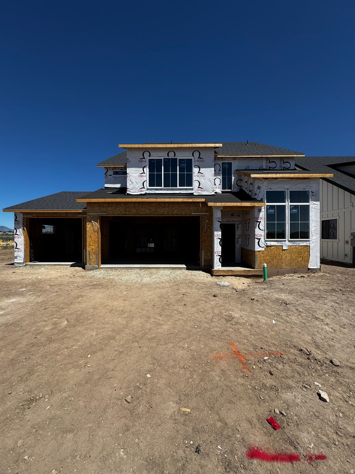 New construction residence featuring a multi-level roofline, extensive window placement, and an attached three-car garage