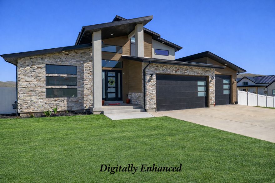 Stunning 6-bedroom, 3.25-bath Mountain Modern two-story home in the highly sought-after Arrival subdivision of Eagle Mountain, situated on 1-acre horse property. The inviting main level showcases vaulted ceilings and an open-concept design with a gourmet kitchen featuring a gas range, double ovens, rich dark cabinetry, granite countertops, a spacious center island, and a generous walk-in pantry. The adjoining family room centers around a striking double-sided fireplace-perfect for cozy evenings indoors or enjoying the covered patio outside while taking in sweeping mountain views. The main-floor owner's suite is a true retreat, offering a spa-inspired bath with dual vanities, a large soaking tub, separate walk-in shower, and an expansive walk-in closet. A dedicated office/flex room on the main level provides the perfect space for remote work, hobbies, or a formal sitting area. Upstairs, you'll find a spacious loft, three additional bedrooms, and a full bath-ideal for family or guests. The fully finished basement expands your living options with a 2nd family room, kitchenette, private entrance, two bedrooms, and a full bath, making it well-suited for a mother-in-law apartment or rental opportunity. The mudroom/Laundry room has a built-in bench with cubbies and hooks for bags, shoes and coats. Car enthusiasts and outdoor adventurers will love the oversized 4-car garage with apoxy floors and ample room for vehicles, tools, and recreational toys, including an RV or boat. The landscaped yard includes lawn, sprinklers, garden beds, and a fully fenced backyard, with plenty of space for horses and outdoor enjoyment. Residents enjoy direct access to community trails for hiking, biking, and horseback riding, along with a 2-acre neighborhood park featuring a playground, pavilion, and open green space. Nestled in the scenic foothills of Eagle Mountain, this community offers breathtaking 360-degree views, a peaceful rural atmosphere, and convenient proximity to town amenities, including the new Walmart. Experience refined country living with space, style, and versatility-all in one exceptional property.