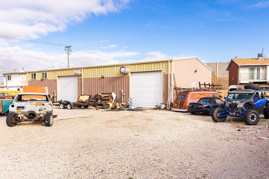 This rare .55-acre lot features an expansive garage, a renovated home, and plenty of fully-fenced land to round out this unique property. This 4 bedroom, 3 bathroom home is being sold turn-key with all furnishings, appliances, decor, linens, and kitchen essentials included. The home also features a private covered patio, outdoor barbeque area with turf, and a carport for 2 cars. A standout feature of the property is the heated two-bay garage, designed to accommodate serious storage and functionality. With a 30-foot depth and 14-foot clearance, it is ideal for RV owners, car collectors, contractors, or hobbyists. Above the garage is additional space, perfect for storage, a home office and/or creative workspace. Conveniently located near I-215 freeway access and Costco, this home offers easy commuting to the Salt Lake International Airport. Zoned R-1-8, this expansive lot provides ample room for RV parking, trailers, and equipment, making it well-suited for multi-generational living or those needing room to grow.