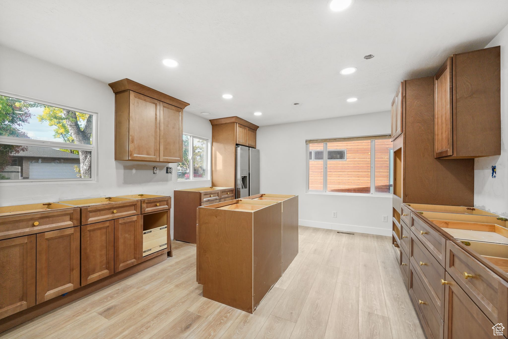 This fully remodeled home is nearing completion and is ready for a buyer to select the final finishes. Featuring 5 bedrooms, 4 bathrooms, 3 kitchens, and 3 separate laundry hookups, it offers flexible living options for the next owner's needs. Large windows and multiple decks showcase incredible views of your half-acre lot from every level of the home. Offered as-is for $1,250,000, with the option to have the current contractor and team complete the remaining interior work for $60,000. Located on a quiet dead-end street with a beautiful lot with a creek running through it in the heart of Salt Lake City, this property combines privacy, space, and convenience-ready for its next owner to bring their vision to life.