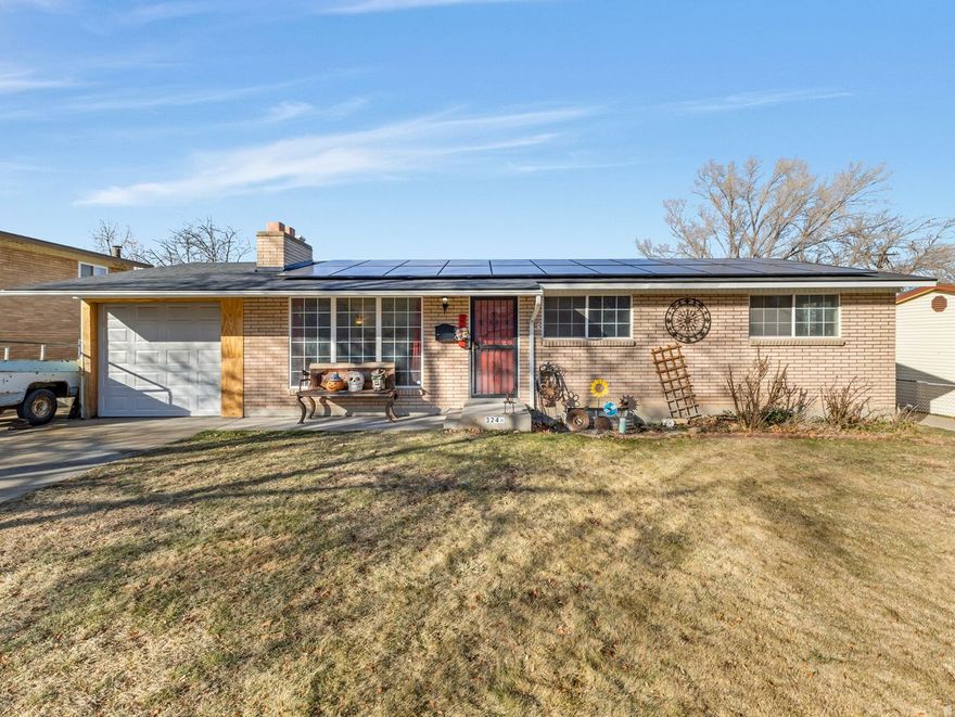 Enjoy the original hardwood floors along with the original matching doors and cabinets in this well-built brick rambler located in a quiet neighborhood. This is a favorite Tooele neighborhood because it is quiet, but  still close to schools, parks, the city pool and library and historic downtown Tooele.  You'll feel right at home in the large living room with a picture window and enjoy dinner time in the eat-in kitchen with appliances included.  The bedrooms, including a primary suite, are roomy and comfortable.  The basement has a bedroom and family room, along with storage galore. The spacious lot is fully fenced with room to play and relax to your heart's content.  Both the home and shed have 2-year old roofs.