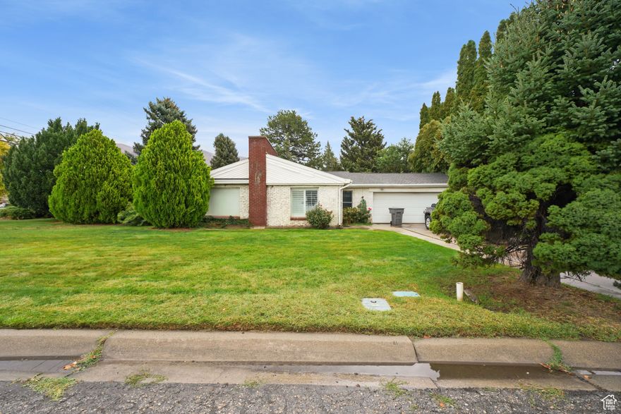 Charming single-level home in a desirable, established American Fork neighborhood! This mature home is surrounded by beautiful, mature trees and landscaping, offering plenty of shade and privacy. While the interior could use some cosmetic updates and decluttering to make it truly shine, the potential here is undeniable.  Enjoy a spacious backyard-perfect for gatherings, gardening, or simply relaxing outdoors. Sitting on a corner lot, this property also offers rare vehicle access directly into the backyard, ideal for storing trailers, toys, or creating your dream workshop space.  If you're looking for a home with great bones, character, and endless possibilities in a fantastic location, this is the one. Seller will need 30 days post-closing to move. Used Aligned to schedule showings.  Buyers to verify all information and accuracy of acreage and square footage. This is provided as a courtesy only.