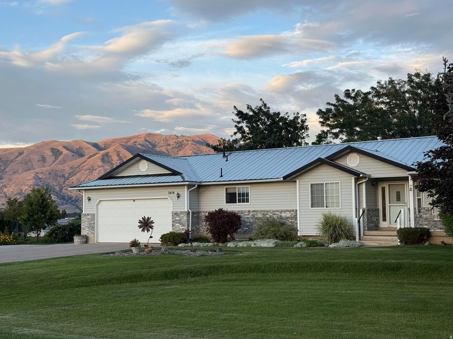 Enjoy peaceful country living in this charming Rambler located in beautiful Paradise Utah. Situated on .87 acres, this 4 bedroom 3.5 bath home offers incredible mountain views to the east and west and abundant natural light throughout. The east-facing sunroom is the perfect place to relax and take in stunning mountain scenery. The basement features a separate outside entrance, offering flexible living options. Additional interior highlights include: a large craft room downstairs which could be an additional bedroom, huge cold storage with built-in shelving, large cedar closet, a large laundry room/mud room off the garage,  and so much more. The property also includes a large 660 square foot detached workshop / garage, ideal for hobbies, storage, or extra parking. The spacious garden area is already plowed and ready for planting. A perfectly quiet, private setting while still being conveniently located within 15 minutes of restaurants, shopping, and Utah State University.