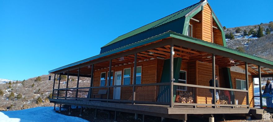 Live your best life in this fully self-sustained, off-grid year round cabin retreat just 90 minutes from Salt Lake City. Set on 18 private acres and bordering association land, this secluded property offers unparalleled privacy, comfort, and adventure.    The main cabin features single-level living with the primary bedroom on the main level.  Additionally, the spacious loft comfortably sleeps 8. A separate guest cabin makes it easy to host family and friends. With solar power, a 1,000-gallon gravity-fed water system, a propane tank, and a private septic system, you're set up to visit your favorite place year-round.    Enjoy endless recreation right on your property:  Trails for exploring, a zip line,  Golf pad,  Clay pigeon shooting range, and breathtaking mountain views.    The property includes three 20-foot shipping containers for storage, two additional prepped pads for future guest cabins-one with power already in place.  All the equipment you need is included:  Mini excavator, Skid steer,  and a Side-by-side with winter tracks  and plow.  Additional 40-foot container to house equipment available.    Sold fully furnished-just bring your favorite people and enjoy.     Square footage figures are provided as a courtesy estimate only and were obtained from Owner measurement.  Buyer is advised to obtain an independent measurement.