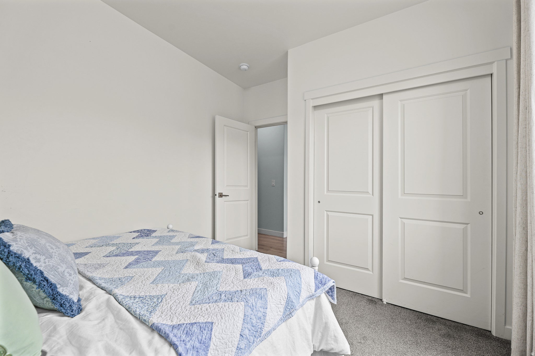 Recessed lighting and a white paneled door
