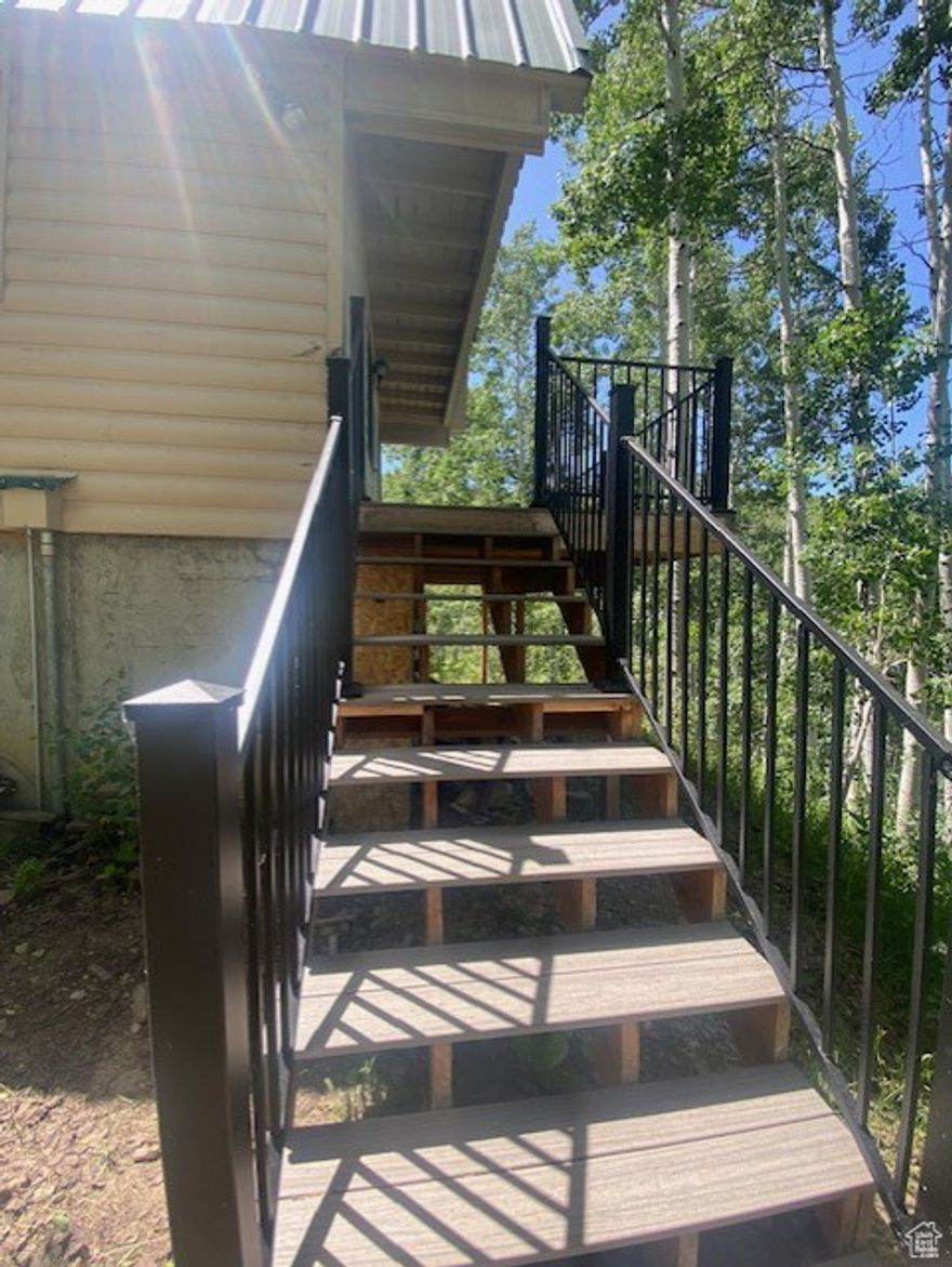 Discover an exceptional opportunity in Tollgate Canyon, where your bucket list of living in the mountains awaits you. This secluded property is perfectly positioned to provide you with the ultimate mountain lifestyle, whether you're an avid skier, a nature enthusiast, or simply in search of your dream home surrounded by natural beauty. As you arrive, you'll be greeted by a treelined, landscaped setting boasting seclusion and views that surpass expectations. This 2-bed, potential 3, 2-full-bath home can serve as the perfect weekend getaway or a year-round residence.