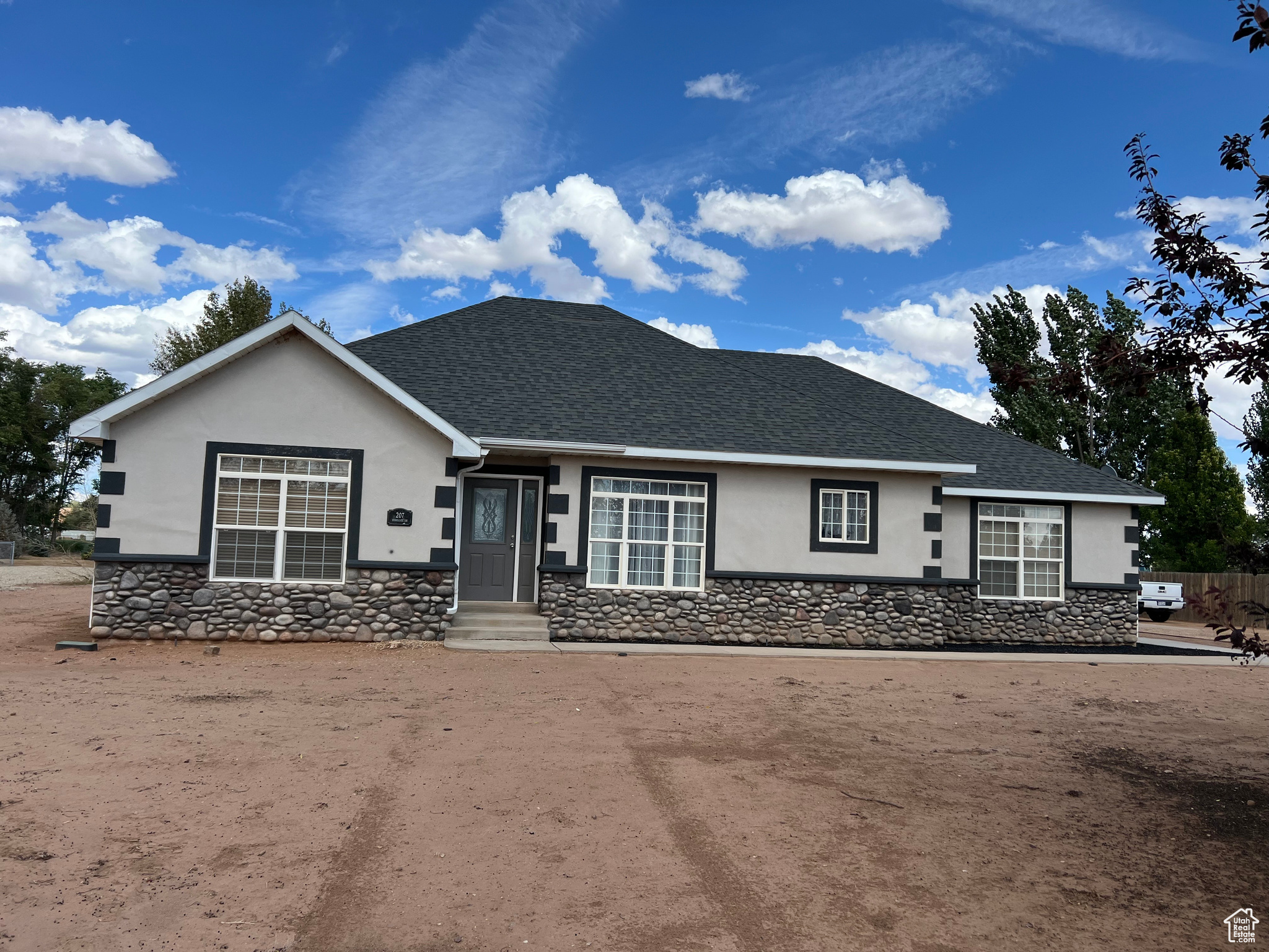 Beautiful 4-bedroom, 2-bath rambler on 1.32 acres in the quiet Stonegate neighborhood of Roosevelt! Built in 2005, this 1,871 sq ft home offers single-level living with a spacious open layout, formal living room, and large family room. The kitchen includes a range, refrigerator, microwave, built-in dishwasher, and dining space, with easy access to a patio for outdoor entertaining. The primary suite features a walk-in closet, jetted tub, and separate shower. Additional highlights include 1 water share ($150/Year) vaulted ceilings, hardwood and tile flooring, double-pane windows, central air, propane forced-air heat, and electric dryer hookup. Paint your own blank canvas with a yard that you can craft to your liking. The 2-car attached garage provides storage, plus RV parking for all your toys. Outside, enjoy mature trees and mountain views-all on a flat, usable lot ideal for animals or a garden. fridge, and microwave are included. Don't miss this chance to own a well-cared-for home with space to grow!