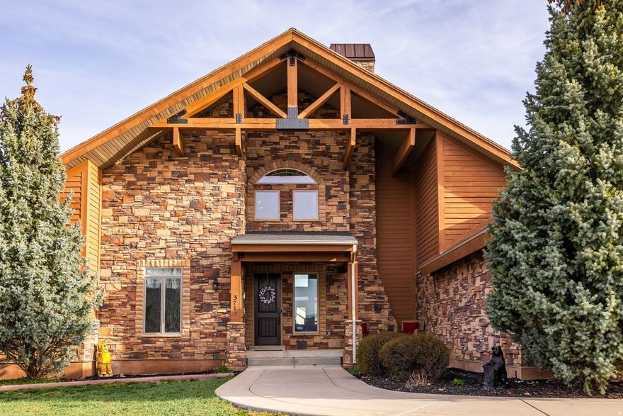 Nestled in picturesque Eden, this exquisite custom-built home offers breathtaking 360-degree views of Ben Lomond Mountain Range and Nordic Valley. Located in the desirable Eagle Ridge neighborhood just below Powder Mountain, this property provides unbeatable access to year-round recreation-just 7 miles to Powder Mountain, 15 minutes to Snowbasin and North Fork Park, and 5 minutes to Pineview Reservoir and Nordic Valley. Enjoy nearby hiking trails, local shops, restaurants, and preserved open space with abundant wildlife. Designed with both comfort and entertaining in mind, the home features an expansive outdoor deck that spans the entire back of the home, perfectly positioned to capture the surrounding mountain and valley views. The beautifully landscaped backyard includes a firepit and hot tub, creating a private and relaxing outdoor retreat. Inside, the main level offers an open-concept layout highlighted by soaring 24-foot ceilings, exposed timber beams, and abundant natural light. This 5 bedroom, 3.5 bathroom home has a spacious primary suite featuring vaulted ceilings, new windows, a   primary suite spa bath with radiant heated floors, freestanding stone tub, marble shower, heated towel rack and quartz dual vanity as well as direct access to a  deck overlooking the backyard. Additional features include two living areas, laundry on both levels, basment kitchenette, office/den space, heated garage with epoxy floor, and a central vac.  Extensive upgrades provide modern convenience and peace of mind, including smart home automation, a Generac whole-home generator, tankless water heater, designer finishes, and a beautifully landscaped backyard. This property presents a rare opportunity to enjoy refined mountain living with stunning views, thoughtful design, and close proximity to world-class outdoor recreation. Make sure to take the time to click on the TOUR button and watch the video and see the 3-D Matterport tour of the home.  Square footage figures are provided as a courtesy estimate only and were obtained from previous appraisal.  Buyer is advised to obtain an independent measurement.