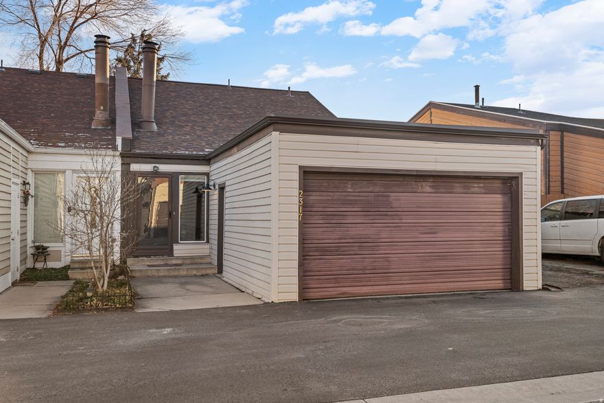 Open House 11-1 01/24/2026!   Thoughtfully updated townhome designed for easy living. Vaulted ceilings and architectural lines create an open, inviting floor plan complemented by a cozy fireplace, updated kitchen with granite countertops, dedicated dining area, nice size pantry, laundry room, and modern finishes throughout. Primary bedroom with en suite offers vaulted ceilings, full bath, large walk-in closet,   Enjoy a fully fenced yard with mature trees and deck space for outdoor entertaining or relaxation.   Rare personal and private, gated RV pad located directly next to the home plus a detached oversized two-car garage with workshop and storage. Newer roof, windows, and exterior doors  make this a standout opportunity in townhome living.