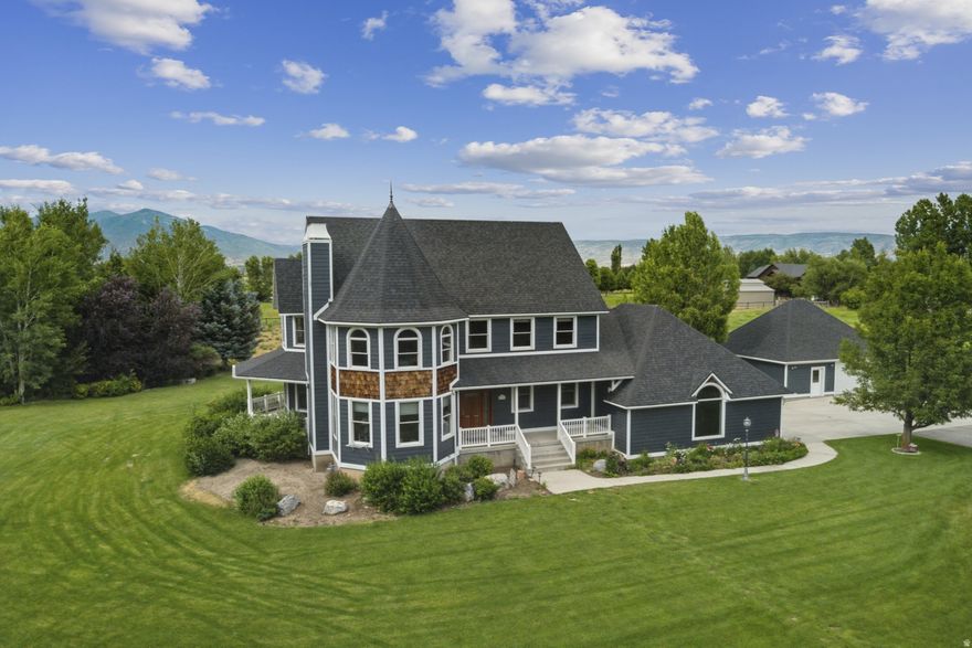 Nestled in the heart of Heber Valley's desirable Charleston neighborhood, is a property that beautifully balances refined craftsmanship with the comforts of rural living. This picturesque HORSE estate sits on 1.85 acres of professionally landscaped grounds, mature trees, full irrigation rights, and expansive wrap-around covered porches that invite you to unwind while taking in Utah's breathtaking mountain vistas. The home itself was updated in 2025 with lifetime shingles, seamless gutters, and a fresh coat of exterior paint that enhances its inviting curb appeal. A heated two-car attached garage is complemented by a separate heated two-car detached garage and workshop complete with a half bath--ideal for hobbyists or those in need of extra storage and workspace. Inside, the home offers exceptional details including solid core hardwood doors, handcrafted moldings, Pella windows, and Emtek brass hardware. A combination of radiant floor heating across seven zones and forced air HVAC across three zones ensures the home remains cozy and efficient year-round. The engineered hardwood floors were specifically chosen to pair with the radiant heat system, elevating both function and style. Every bedroom features custom closet organizers, and a Smart Network backbone plus a security system adds convenience and peace of mind. The luxurious main suite is a spa-inspired retreat, with a granite-tiled bathroom showcasing an Aquatic double-pump jetted tub and multi-head body spray system for the ultimate relaxation. In the kitchen, high-end appliances including an LG wall oven, Bosch dishwasher, Panasonic microwave, and a commercial-grade pellet ice machine cater to both the casual chef and seasoned entertainer. Swing-away bar seating at the island makes hosting family and friends a breeze. This property also boasts practical systems like a central vacuum, a new boiler (installed in 2022 and serviced in 2025), a new furnace (2022), a large 80-gallon water heater and water softener.