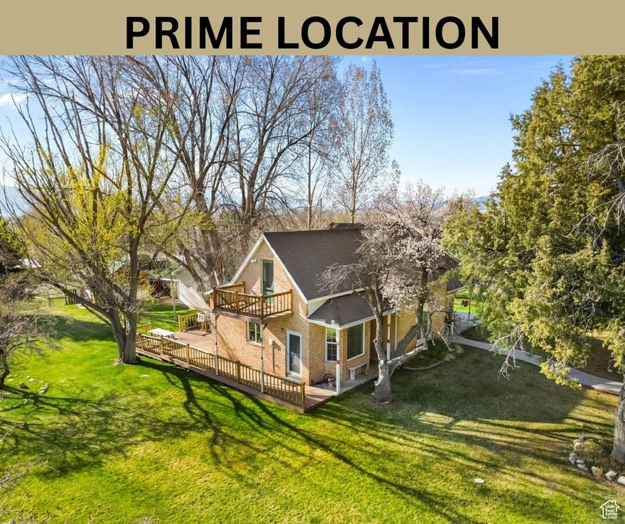 PRIME LOCATION! Historic Charm Meets Modern Luxury in Spring City! Step into timeless elegance with this stunning 4-bedroom, 2-bath home in the Spring City Historic District. Set on a sprawling 1.06-acre corner lot, this property blends classic character with today's comforts - soaring ceilings, original moldings, and gleaming hardwood floors pair beautifully with modern upgrades like a newer furnace, central air, and a 300-gallon gas tank. Cozy up by the gas fireplace or pellet stove, and enjoy breathtaking views framed by apple, pear, and walnut trees. With an oversized detached garage, original smokehouse, and charming chicken coop, this home offers both function and flair. Experience the perfect harmony of history, style, and sophistication - all in one extraordinary home.