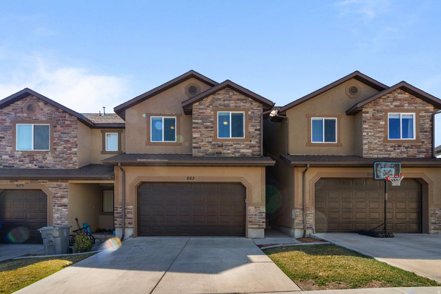 This spacious townhome in Harvest Hills is in a really convenient spot-close to Mountain View Corridor and only about 15 minutes to I-15, so getting around is easy. The neighborhood has a clubhouse with a gym, and you're within walking distance to Harvest Park and Harvest Elementary, which is hard to beat. Inside, the layout feels open and functional, and the kitchen has a cute peninsula that works great for extra seating or just hanging out while cooking. The unfinished basement gives you room to grow or customize down the road (and even includes flooring trim ready for install if you want to finish it out). One thing that really stands out is the small backyard-most townhomes don't offer that, so it's nice to have your own little outdoor space. A big bonus here is the amount of behind-the-scenes work that's already been done. The owners have put over $45K into major updates, including a new A/C compressor, furnace motor, new kitchen appliances and disposal, updated faucets, garage door opener system, and added cupboard hardware. They also installed UV and privacy windows, had the ducts professionally cleaned with UV treatment, and completed a full plumbing line clearing to significantly improve flow capacity. It's the kind of stuff you don't always see, but it makes a big difference in how the home functions day-to-day. The HOA covers water, sewer, and trash, which helps keep things simple. And you're just 510 minutes from Costco, Walmart, restaurants, and pretty much anything else you need.
